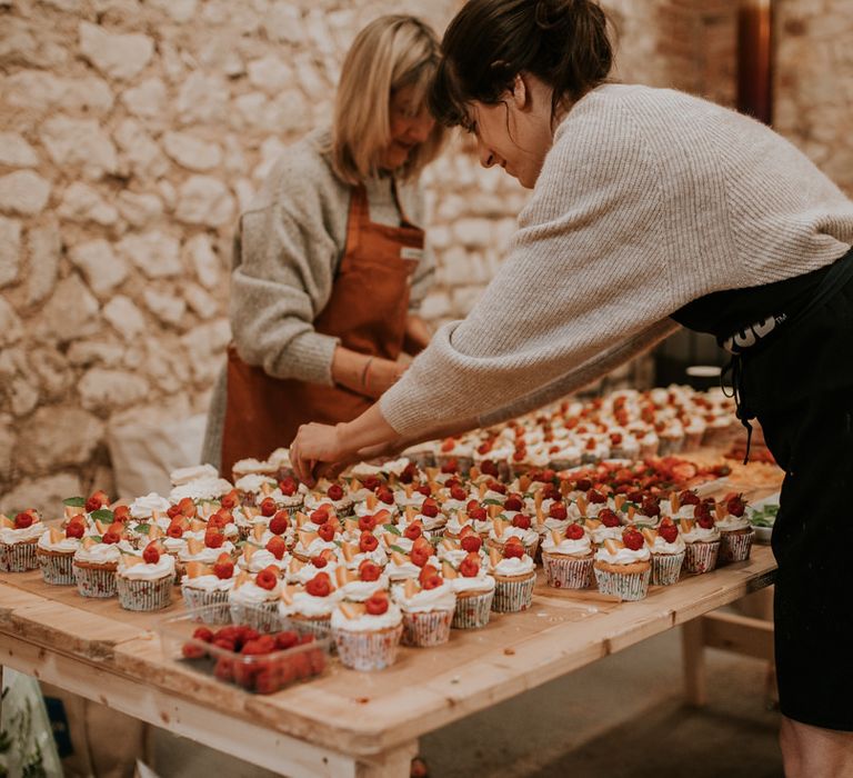 Groom's sister decorates handmade cupcakes