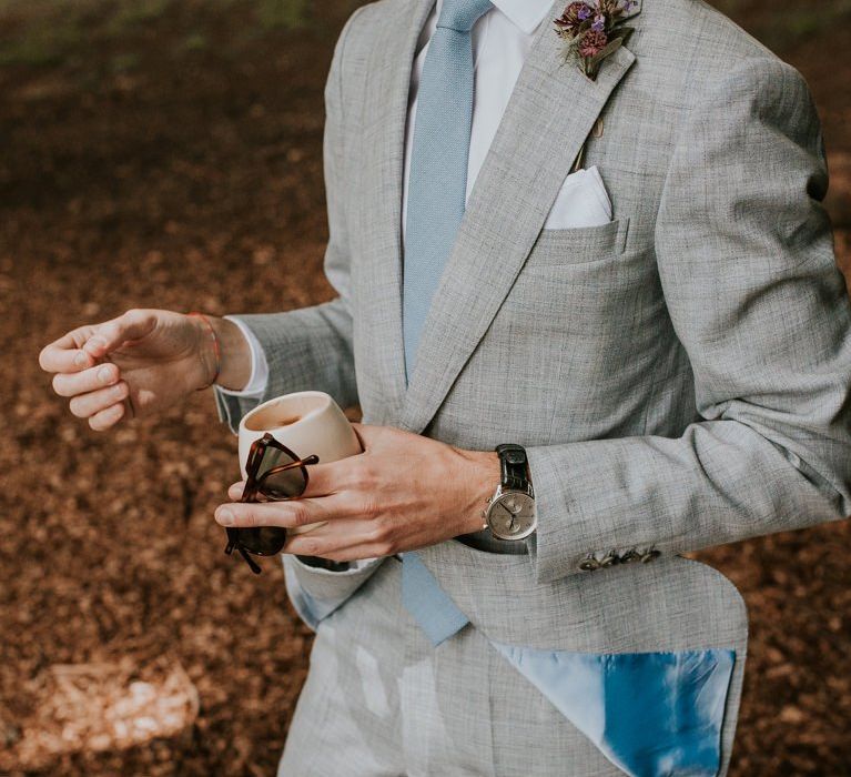 Grey grooms suit with blue tie