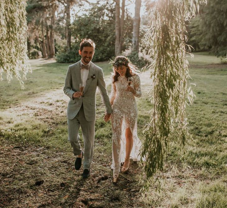 Bride and groom walk through the grounds of the Norfolk wedding venue