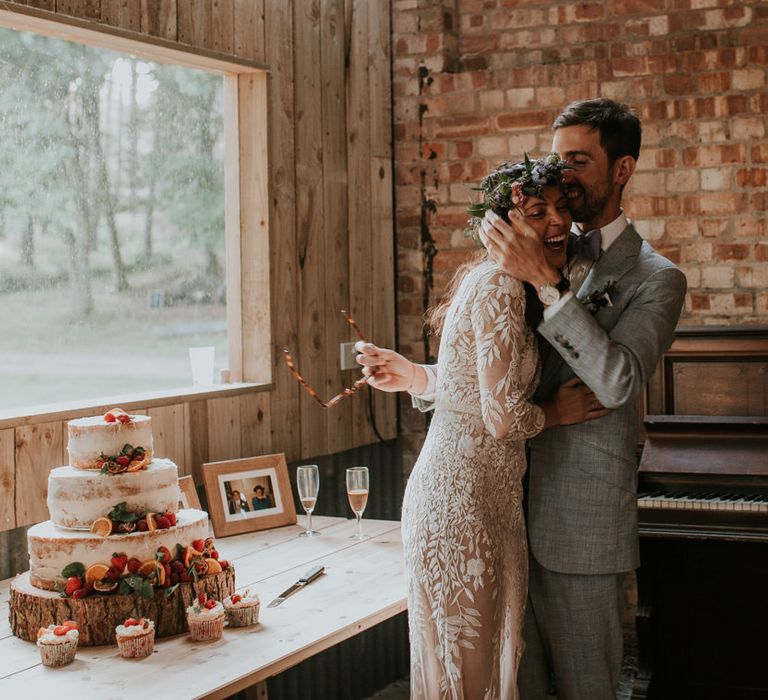 Bride and Groom cut the semi-naked wedding cake