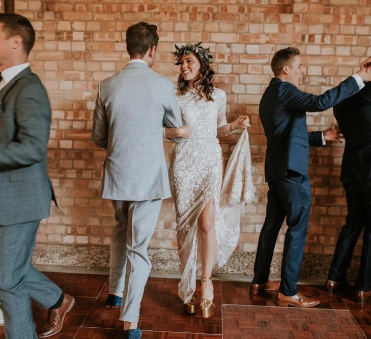 Bride and groom dance with guests