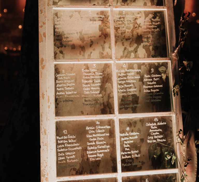 Window pane table plan at romantic celebration with destination wedding planner help