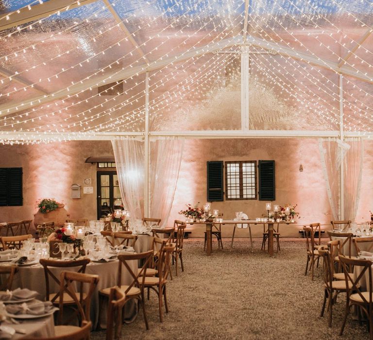 Fairy light canopy draping from ceiling of clear span marquee