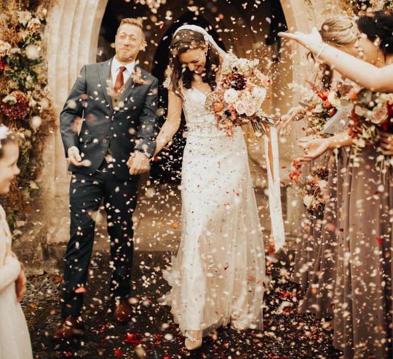 Confetti exit for groom and his bride in Maggie Sottero wedding dress