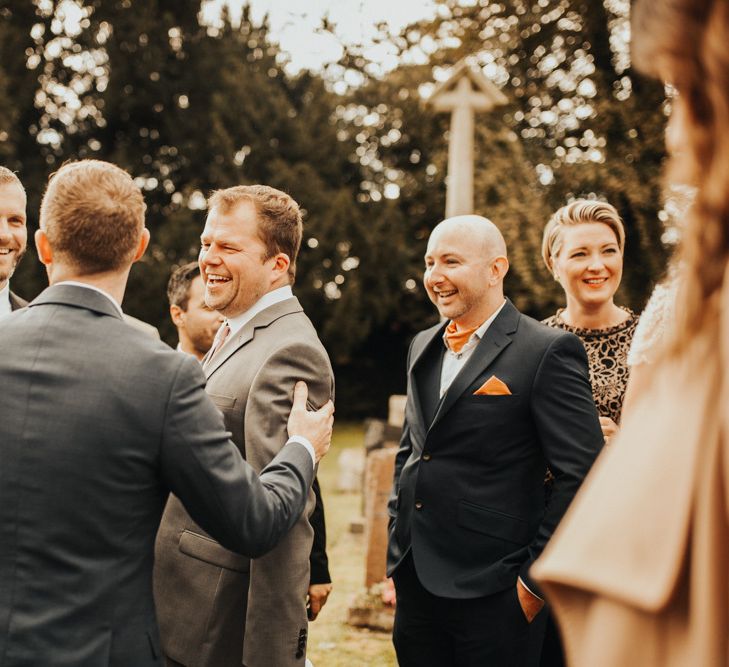 Guests mingle outside church