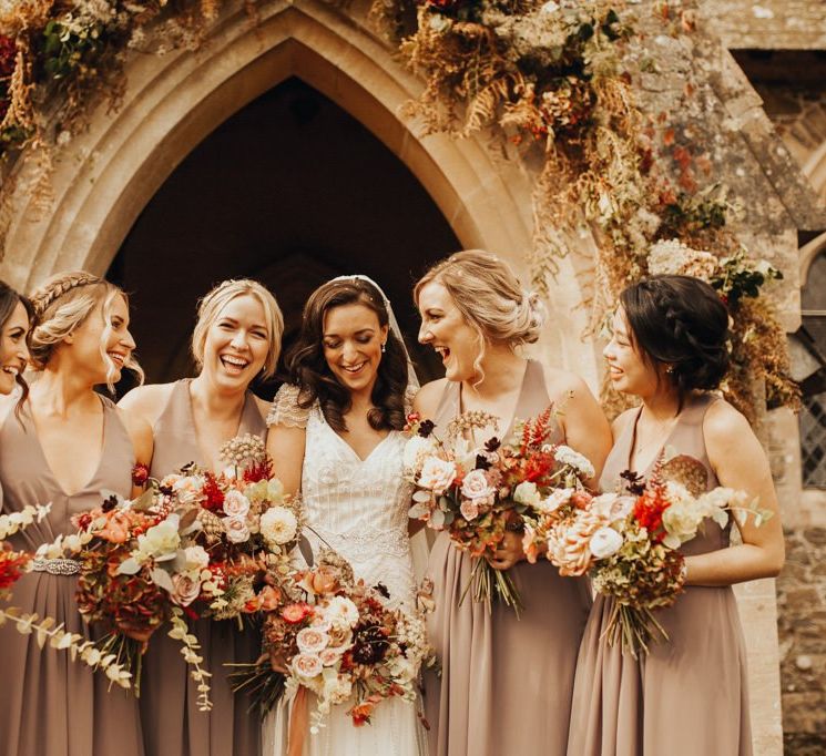 Bride in Maggie Sottero wedding dress with bridesmaids in neutral dresses