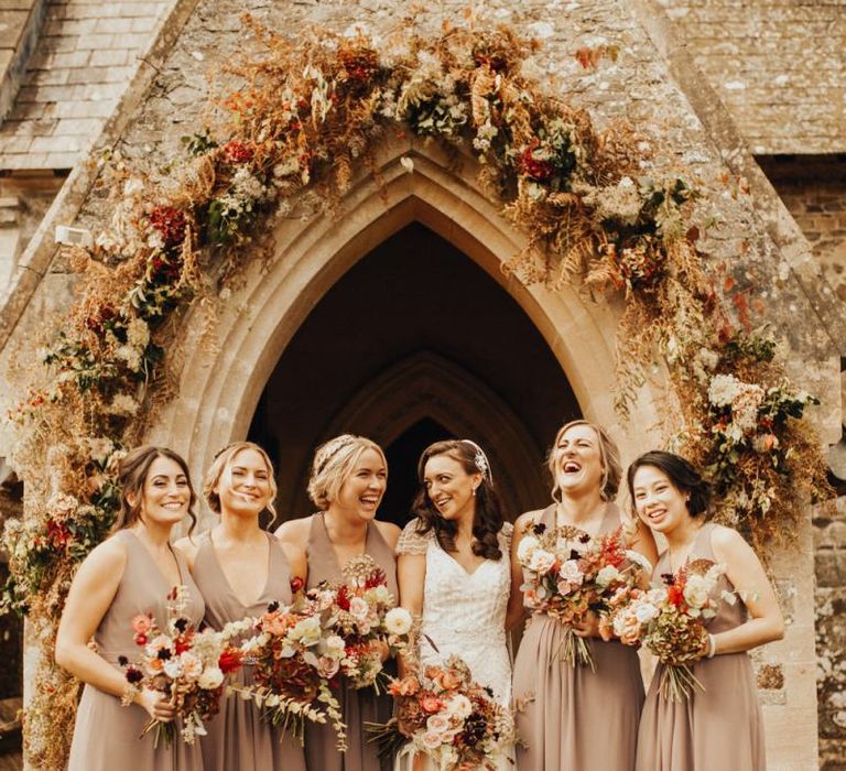 Bride in Maggie Sottero wedding dress with bridesmaids in neutral dresses