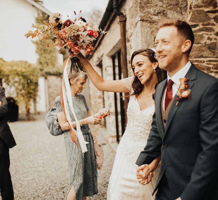 Bride in Maggie Sottero wedding dress with Autumnal bouquet