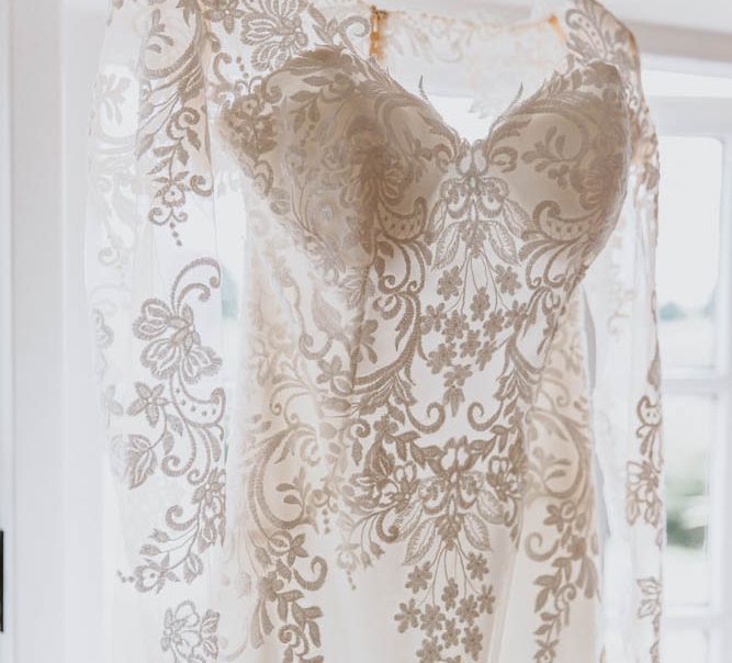 Long Sleeve Lace Sincerity Bridal Wedding Dress Hanging at the Window