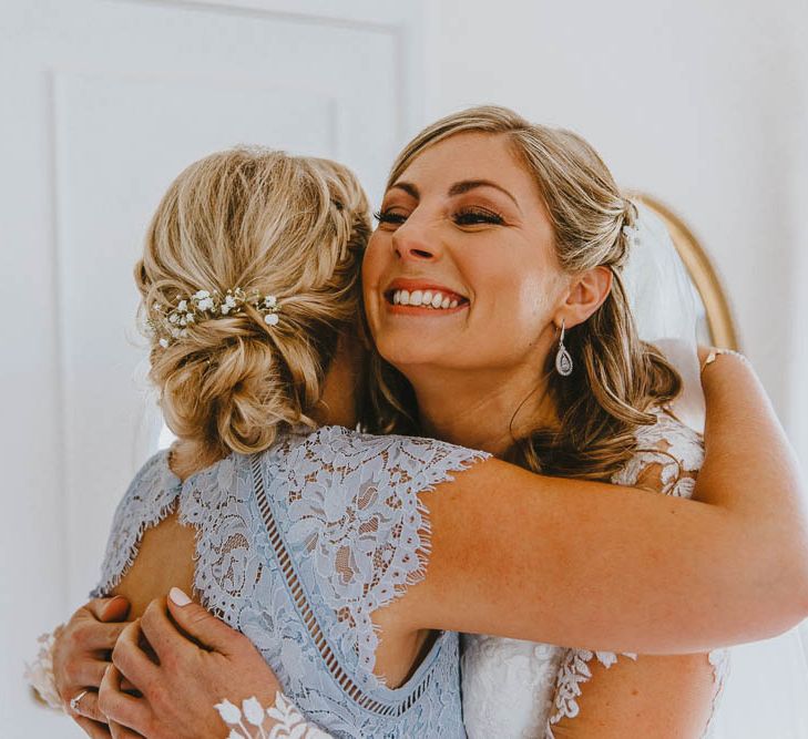 Bridesmaids in Blue Lace Dress Hugging The Bride on Wedding Morning