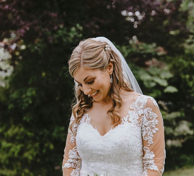 Bride in Lace Sincerity Brides Wedding Dress with Long Sleeves, Pastel Bouquet and Veil