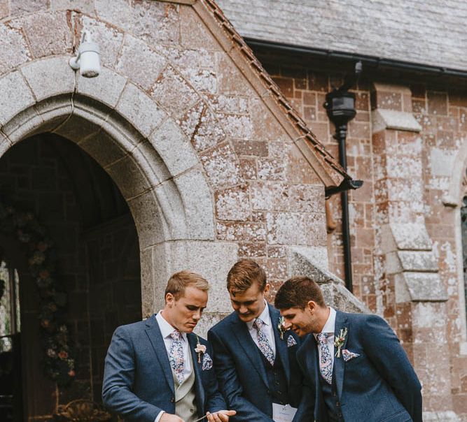 Groomsmen Outside the Church in Navy Suits, Grey Waistcoat and Floral Ties