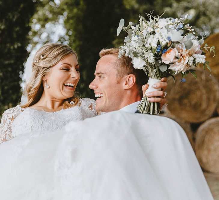 Groom Sweeping His Bride off Her Feet