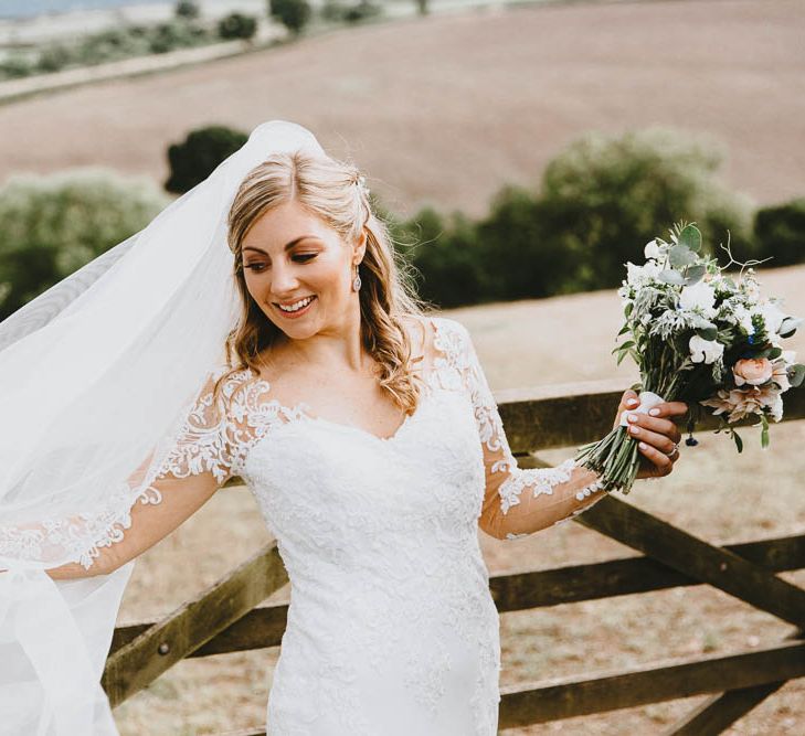 Bride in Lace Sincerity Bridal Wedding Dress with Long Sleeves and Wedding Veil