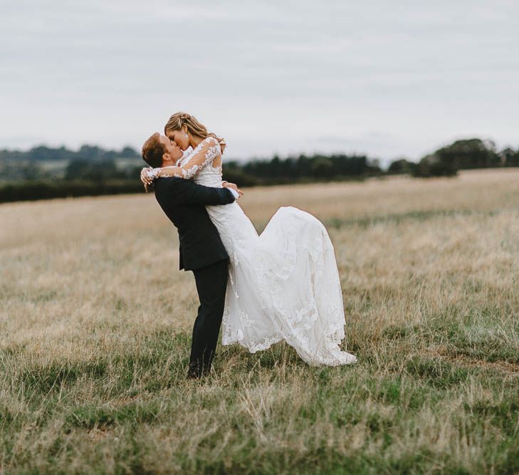 Groom in Blue Ted Baker Suit Picking up Bride in Lace Sincerity Bridal Wedding Dress