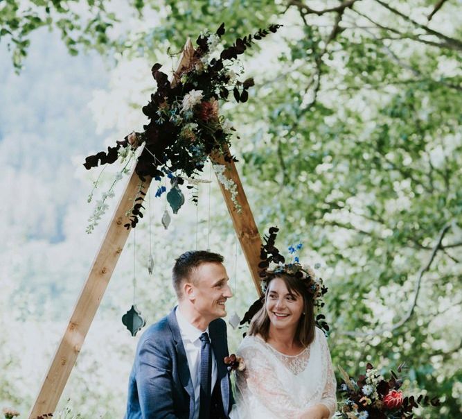 Bride and groom during woodland wedding ceremony