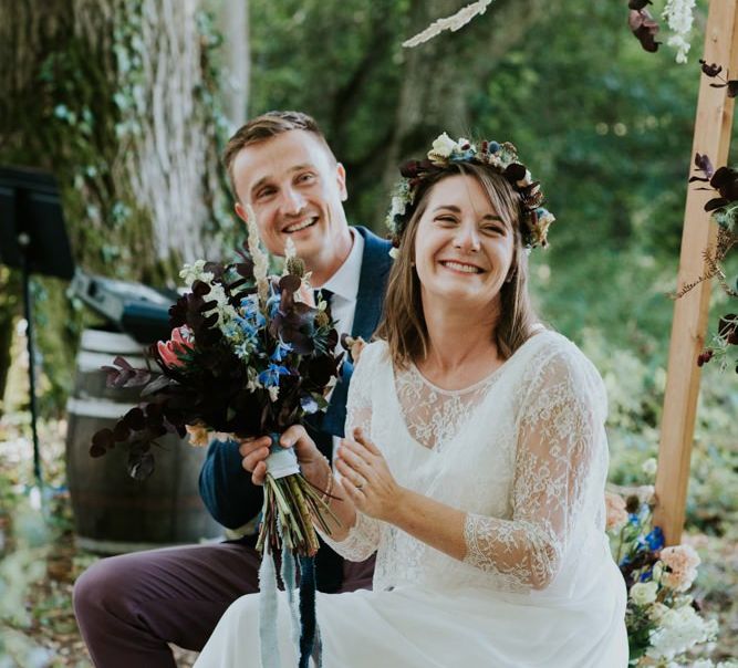 Bride and groom enjoy wedding readings at outdoor ceremony