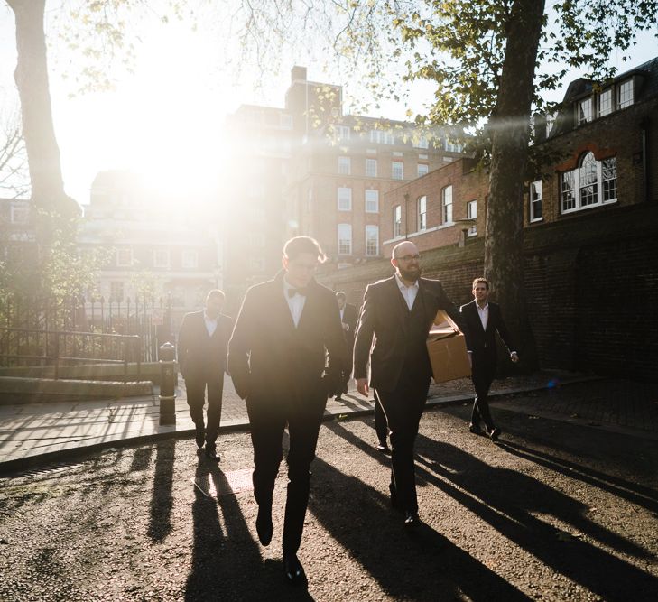 Groom in Chester Barrie Tweed Suit | Candle Lit Christmas Wedding at Gray's Inn London with Christmas Carols &amp; Festive Wreaths | John Barwood Photography