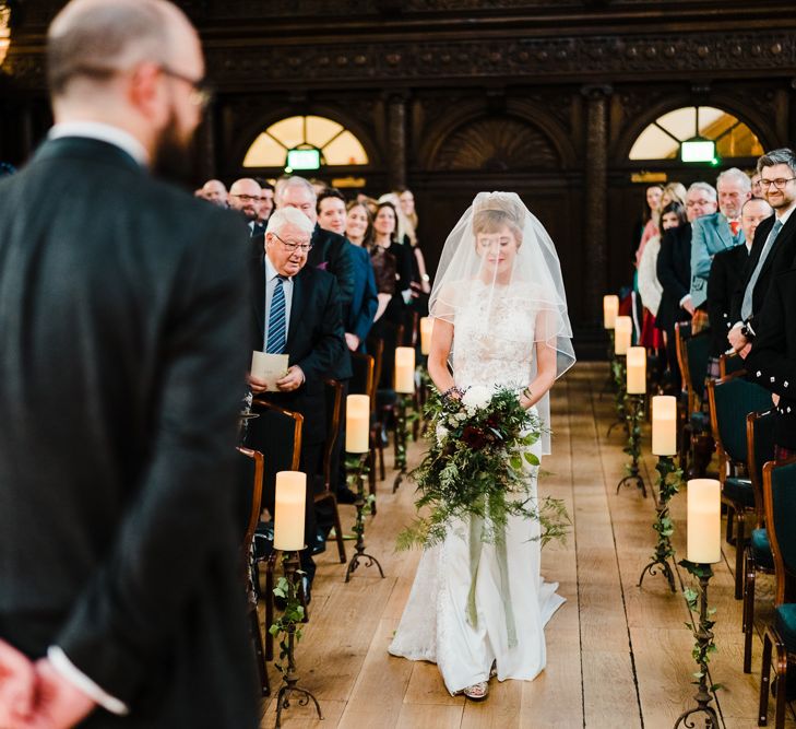 Wedding Ceremony Bridal Entrance in Lace San Patrick Gown &amp; Veil | Candle Lit Christmas Wedding at Gray's Inn London with Christmas Carols &amp; Festive Wreaths | John Barwood Photography