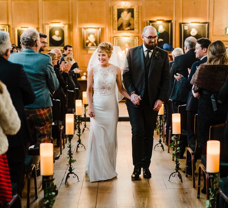 Wedding Ceremony Bride in Lace San Patrick Gown &amp; Veil | Groom in Tweed Chester Barrie Suit | Candle Lit Christmas Wedding at Gray's Inn London with Christmas Carols &amp; Festive Wreaths | John Barwood Photography