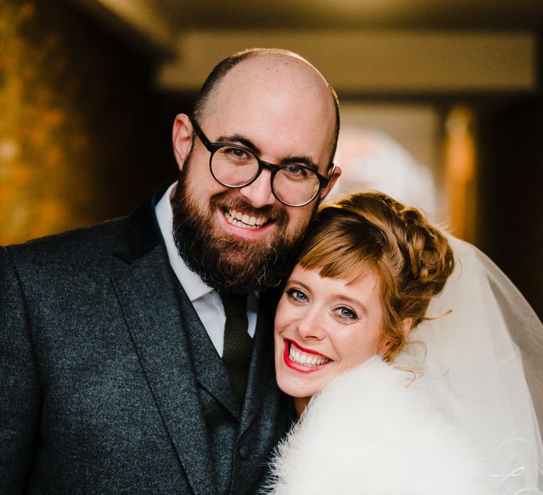 Bride in Lace San Patrick Gown &amp; Fur Coverup | Groom in Tweed Chester Barrie Suit | Candle Lit Christmas Wedding at Gray's Inn London with Christmas Carols &amp; Festive Wreaths | John Barwood Photography