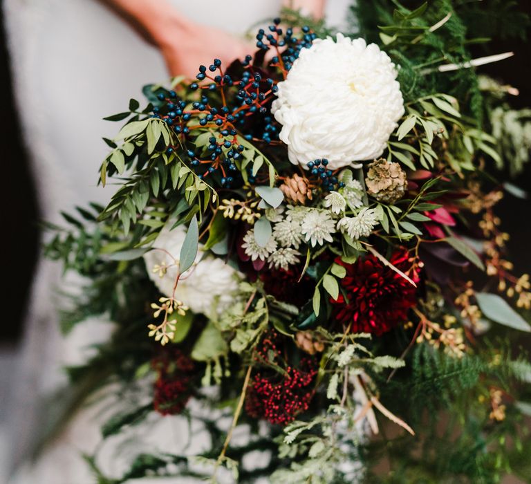 Hand Tied Wedding Bouquet with Foliage, Berries &amp; Blooms | Bride in Lace San Patrick Gown &amp; Fur Coverup | Candle Lit Christmas Wedding at Gray's Inn London with Christmas Carols &amp; Festive Wreaths | John Barwood Photography