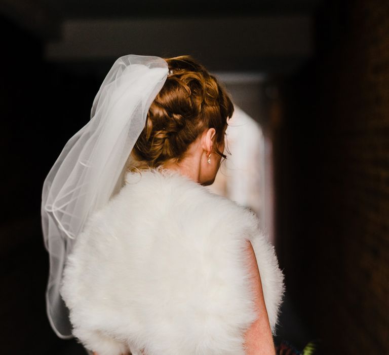 Bride in Lace San Patrick Gown &amp; Fur Coverup | Candle Lit Christmas Wedding at Gray's Inn London with Christmas Carols &amp; Festive Wreaths | John Barwood Photography