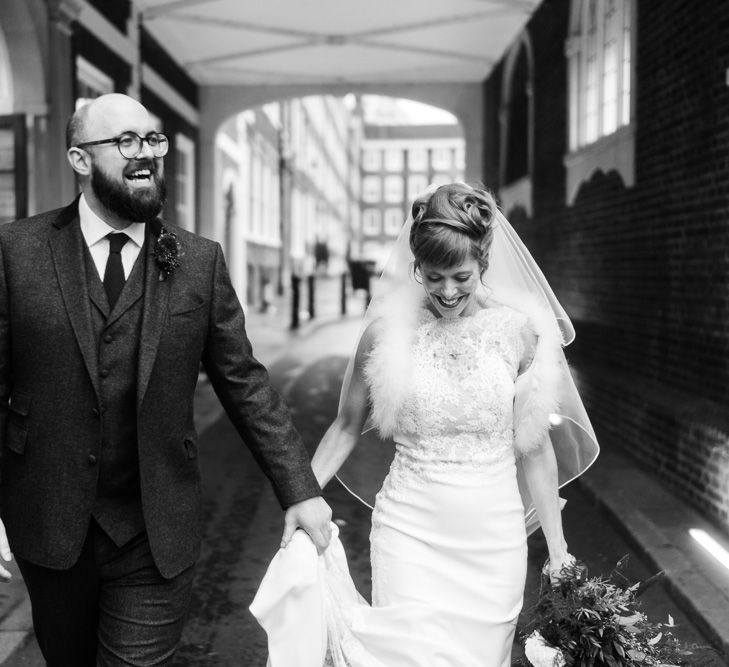 Bride in Lace San Patrick Gown &amp; Fur Coverup | Groom in Tweed Chester Barrie Suit | Candle Lit Christmas Wedding at Gray's Inn London with Christmas Carols &amp; Festive Wreaths | John Barwood Photography