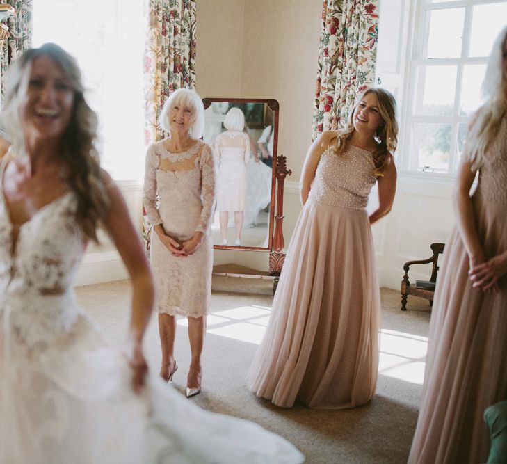 Bride shows bridesmaids dress