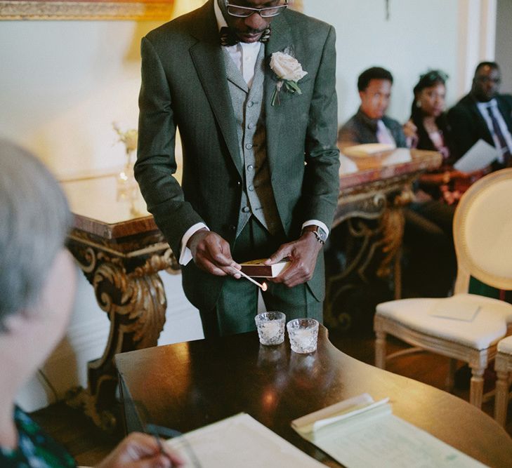 Groom lights candles and waits for bride at ceremony