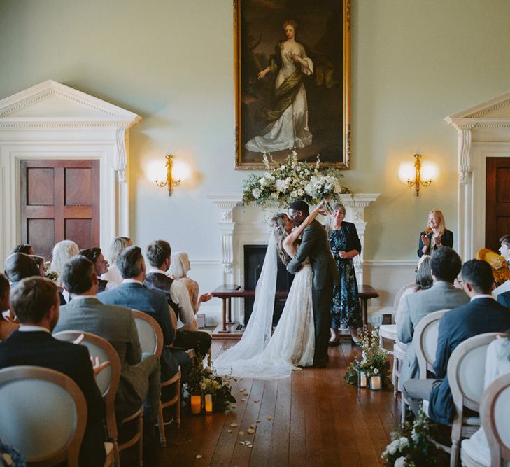 Bride and groom kiss at Kirtlington Park wedding ceremony