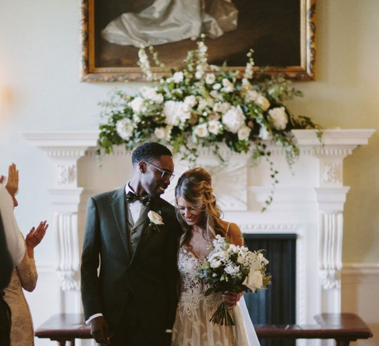 Bride and groom walk up the aisle at Kirtlington Park wedding