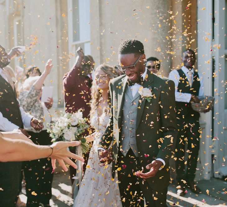 Confetti exit for bride and groom at Kirtlington Park wedding