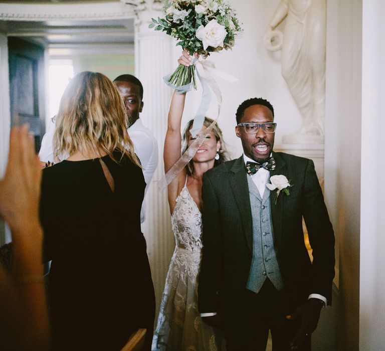 Bride and groom enter wedding breakfast at Kirtlington Park wedding