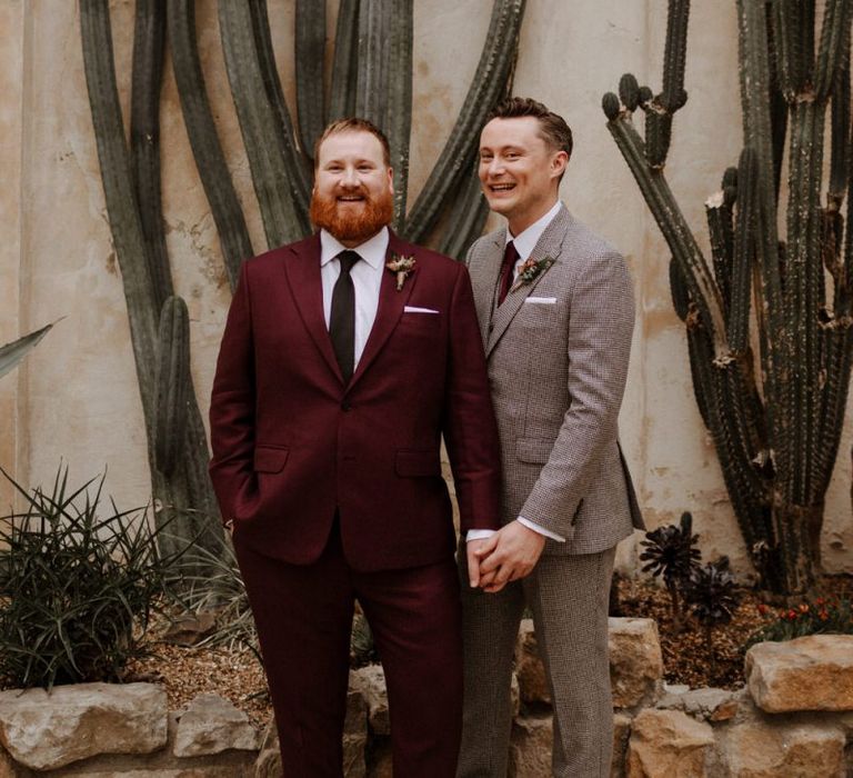 Same sex couple on burgundy and checked suits