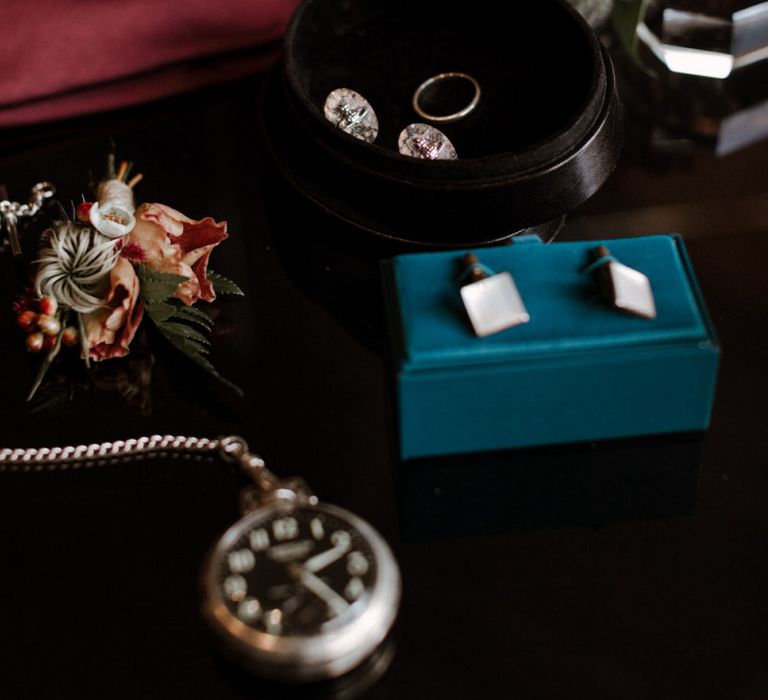 Grooms accessories with cufflinks and wedding band