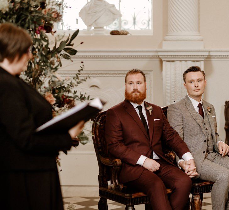 Groom and groom holding hands at Syon Park wedding ceremony