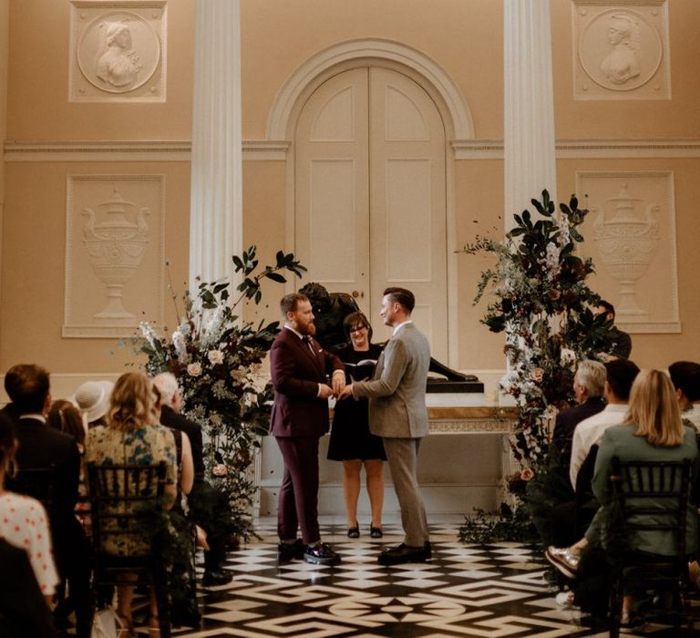 Groom and groom exchanging vows at their Syon Park wedding ceremony