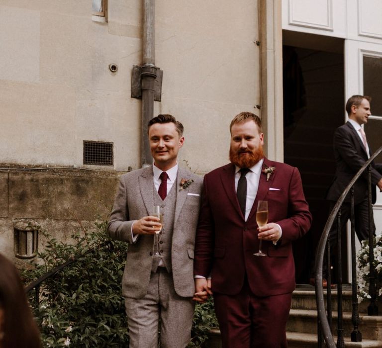 Grooms in burgundy and beige checked suits at Syon Park