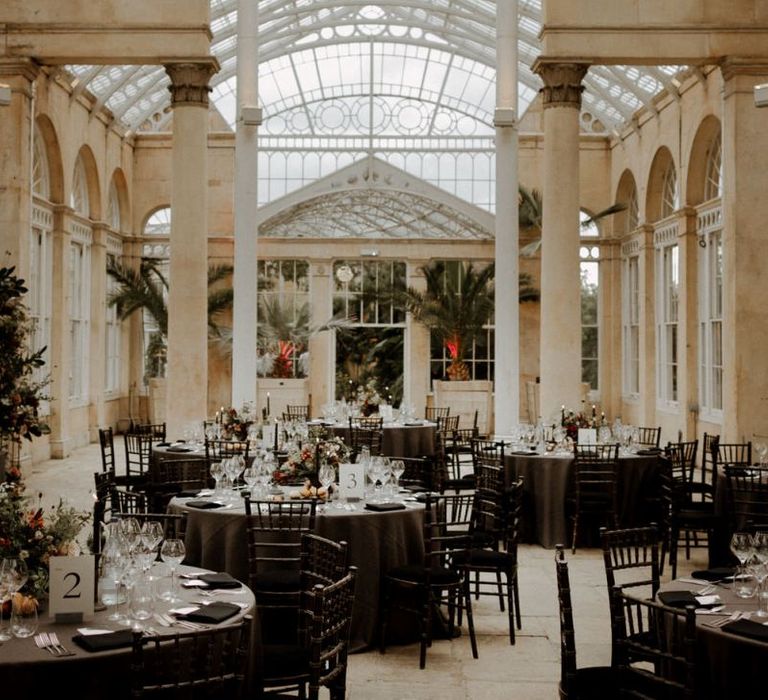 Syon park wedding reception with dark opulent wedding decor and flowers