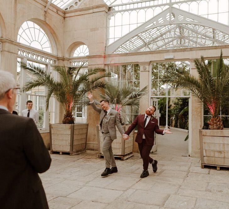 Groom and groom entering the Syon Park wedding reception