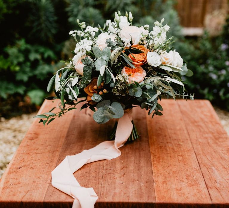 White and peach wedding bouquet tied with ribbon for 2020 wedding