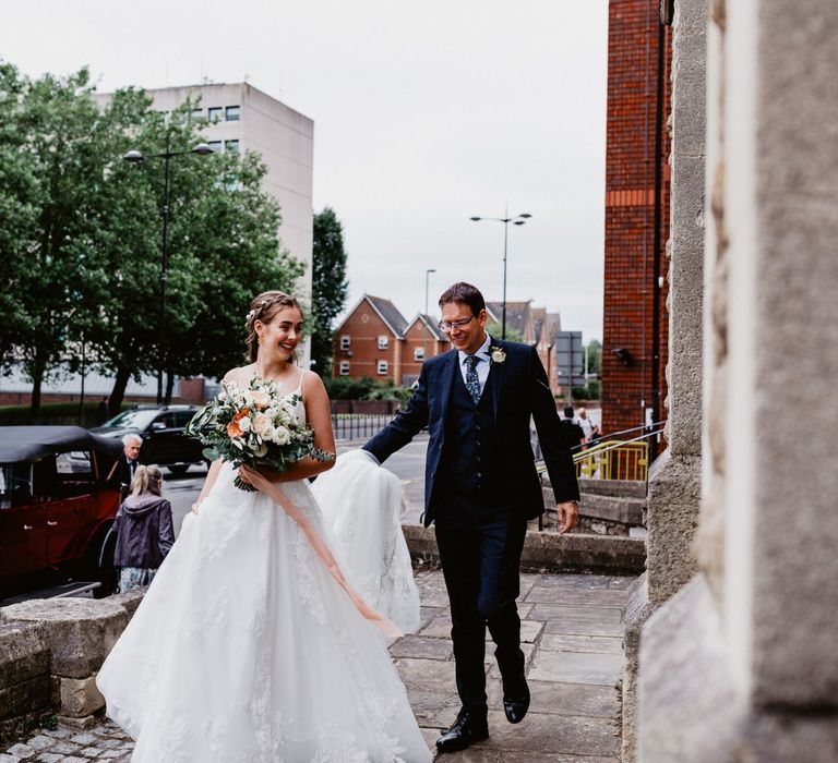 Bride outside the church in Essense of Australia wedding dress