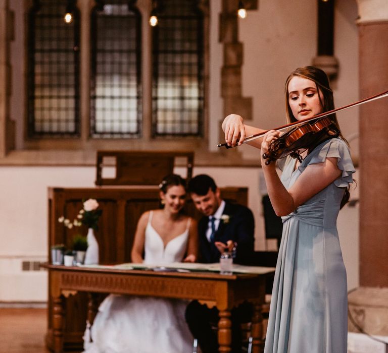 Violin playing whilst the bride and groom sign the register