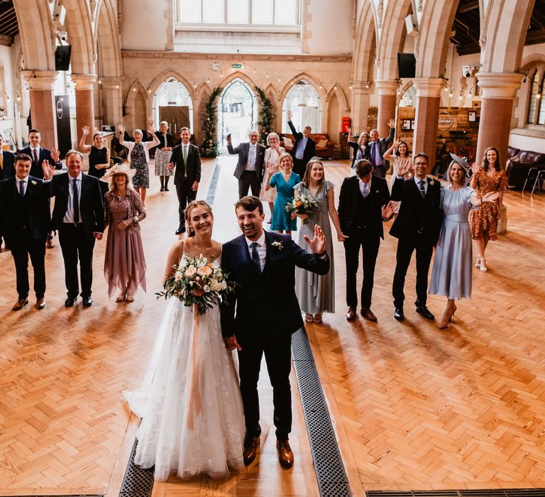 Socially distance wedding guests portrait in the church