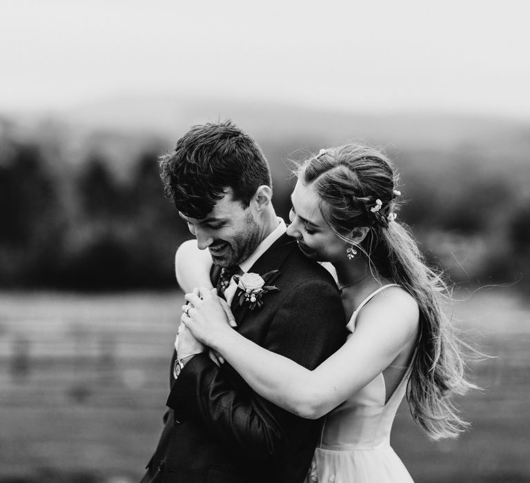 Bride and groom embracing