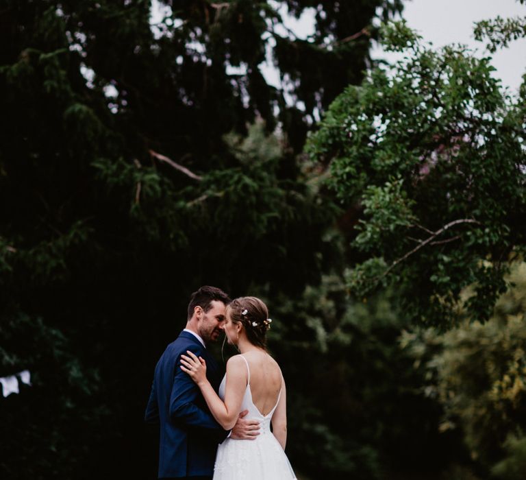 Bride and groom portrait standing in a country lane