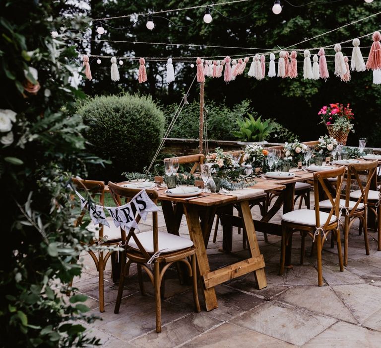 Garden party 2020 wedding reception with tassels and festoon lights