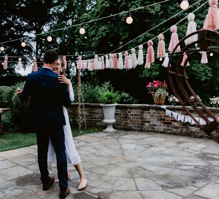 Bride and groom first dance at socially distanced  garden party reception