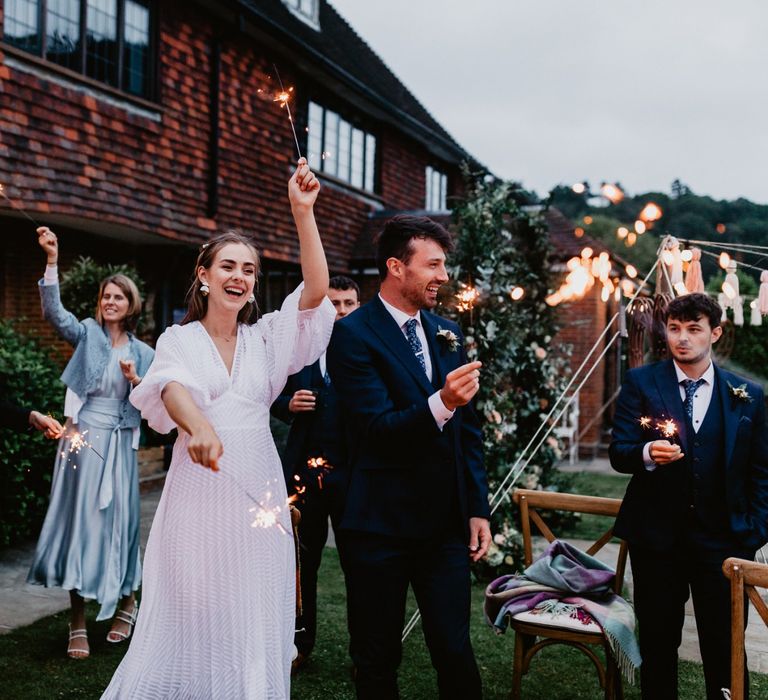 Wedding guests lighting sparklers at 2020 wedding